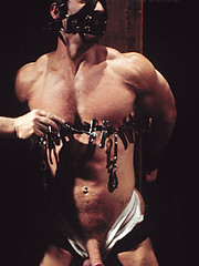Bondaged hunk gets nipple and cock torture