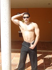 Strong latin guy posing under hot sun