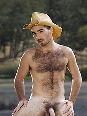 Smiley cowboy man showing his nude hairy chest