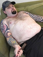 Hairy, tattooed love-stud Rowdy Hixxx strips to show you his furry belly and uncut cock